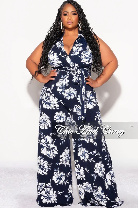 Deal Mania Final Sale Plus Size Faux Wrap Halter Jumpsuit with Waist Tie in Navy and White Floral Print Deal Mania Final Sale Plus Size Faux Wrap Halter Jumpsuit with Waist Tie in Navy and White Floral Print